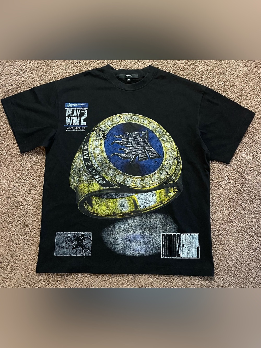 KDNK Black Graphic Tee with Bold Yellow & Blue Ring Design